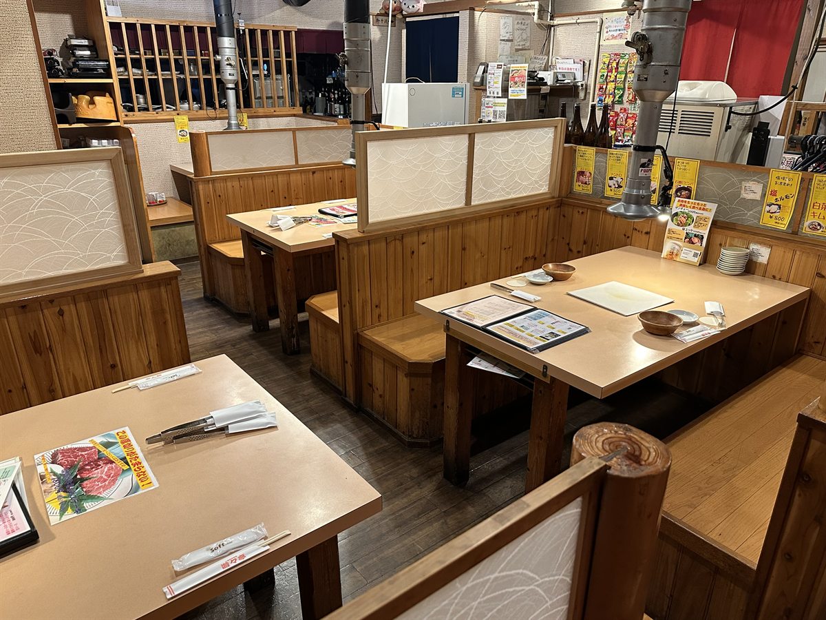 テーブル席。仕切りのあるボックス席が並ぶ店内